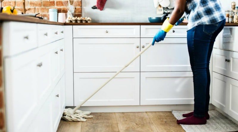 a man mopping the floor